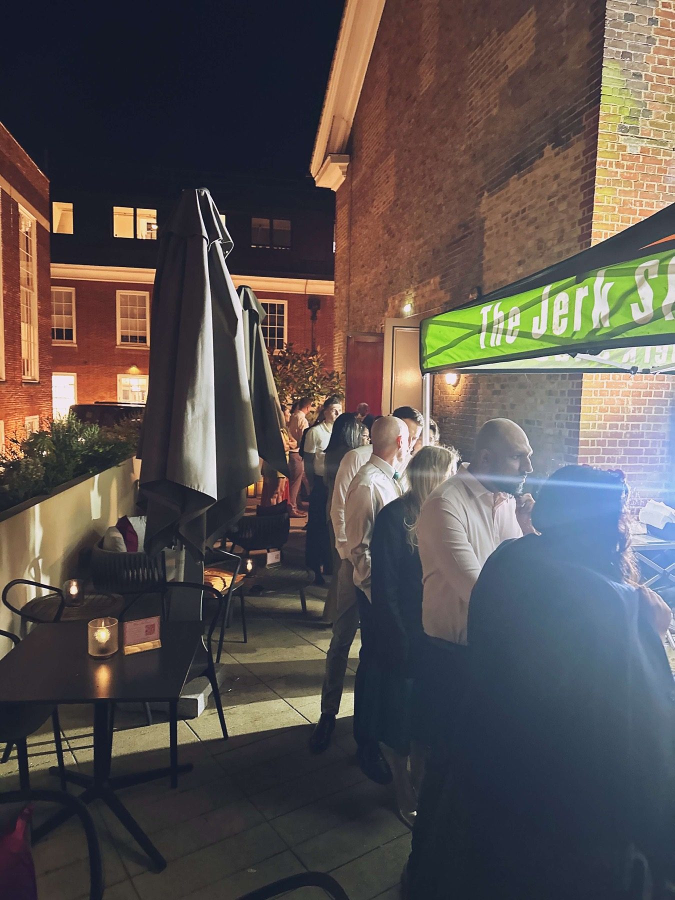 The Jerk Shac catering canopy serving guests at an evening event
