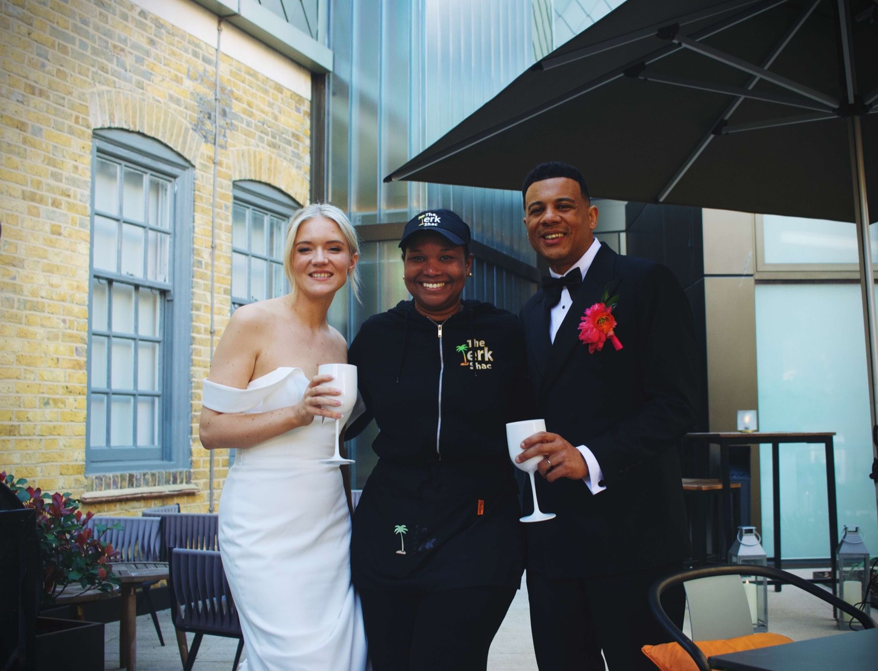 The Jerk Shac team with wedding couple at a catered event