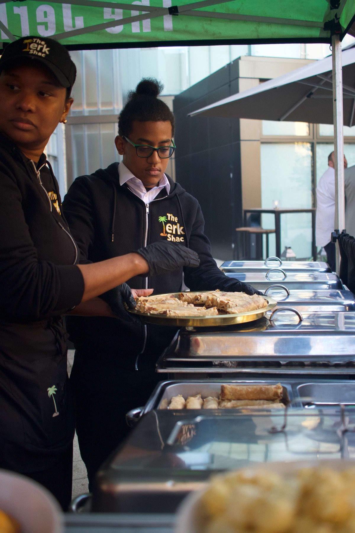 The Jerk Shac team plating catering food trays