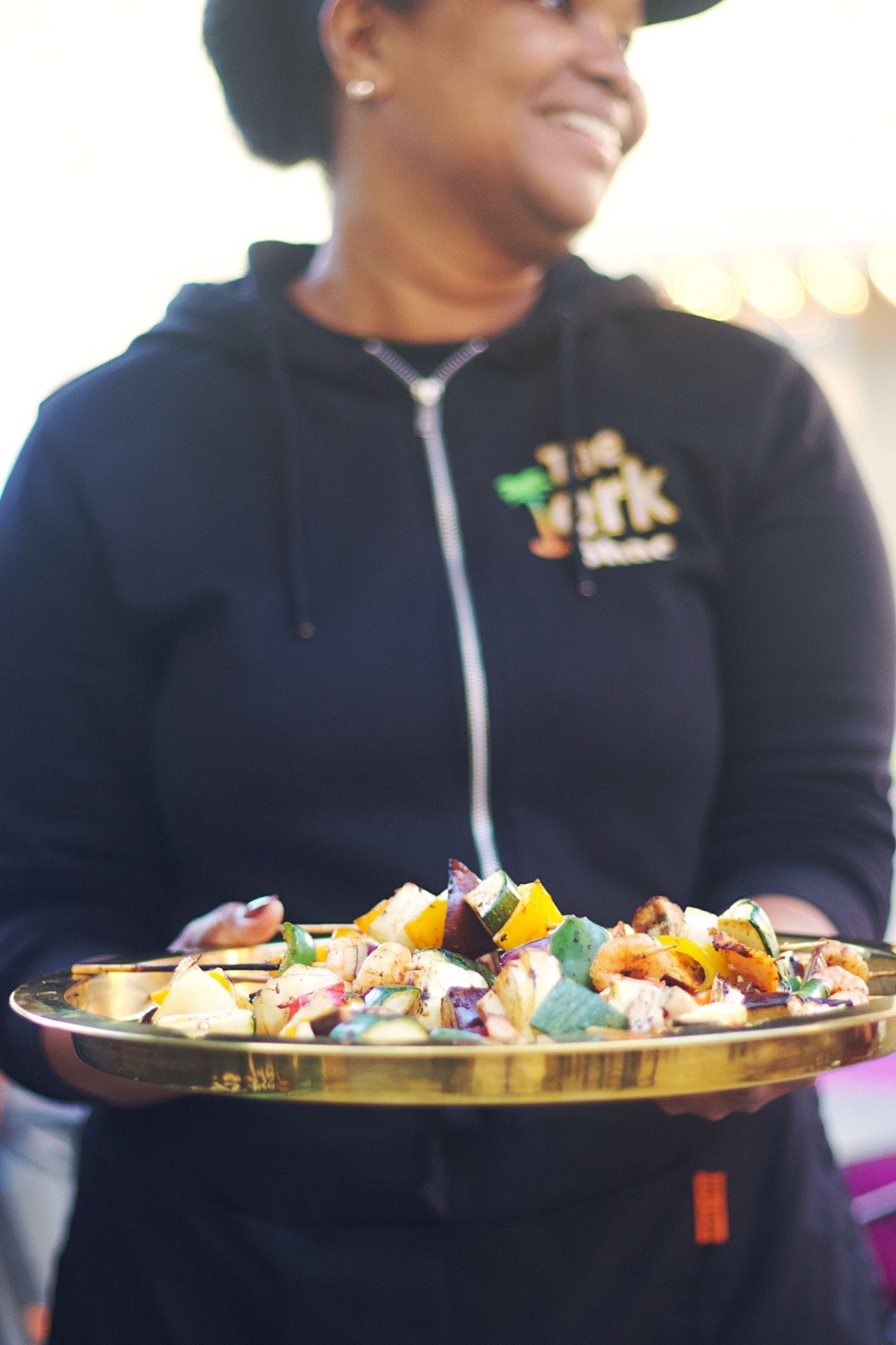 Guest smiling with Jerk Shac catering food