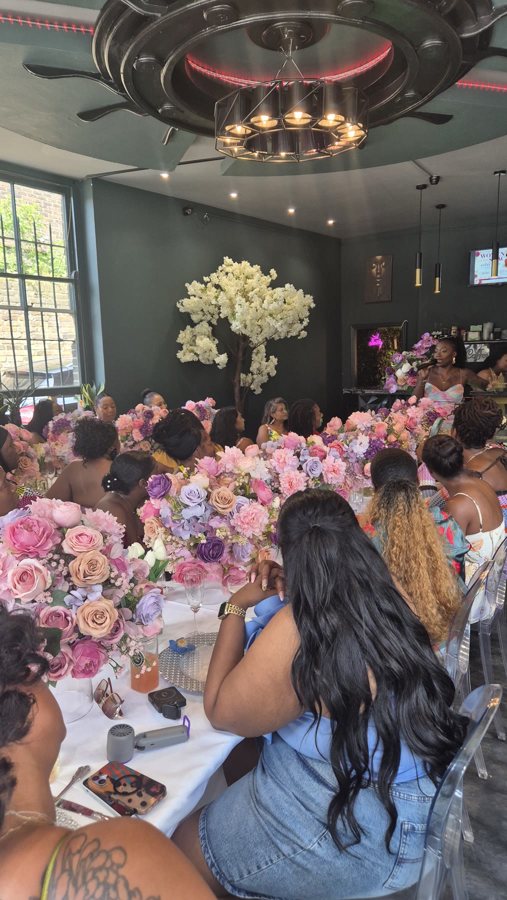 Guests seated around the decorated table during the celebration