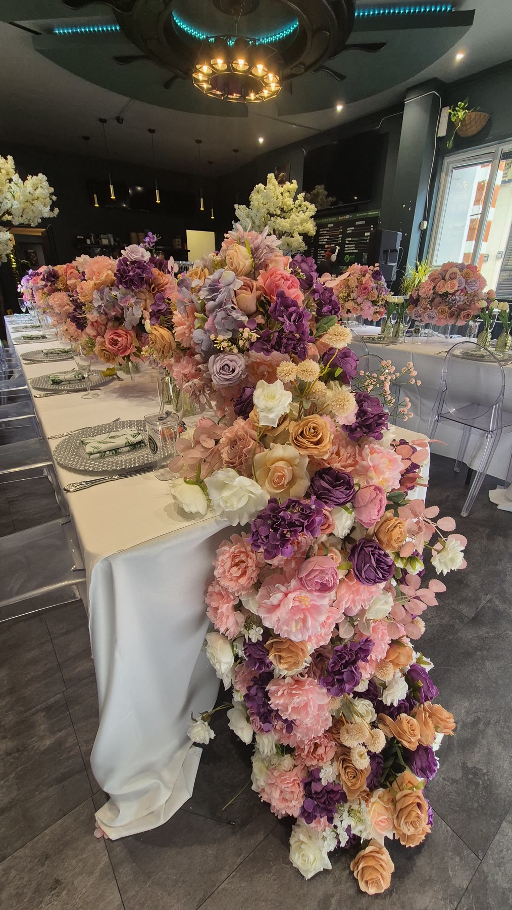 Detailed place setting beside pink and purple flowers